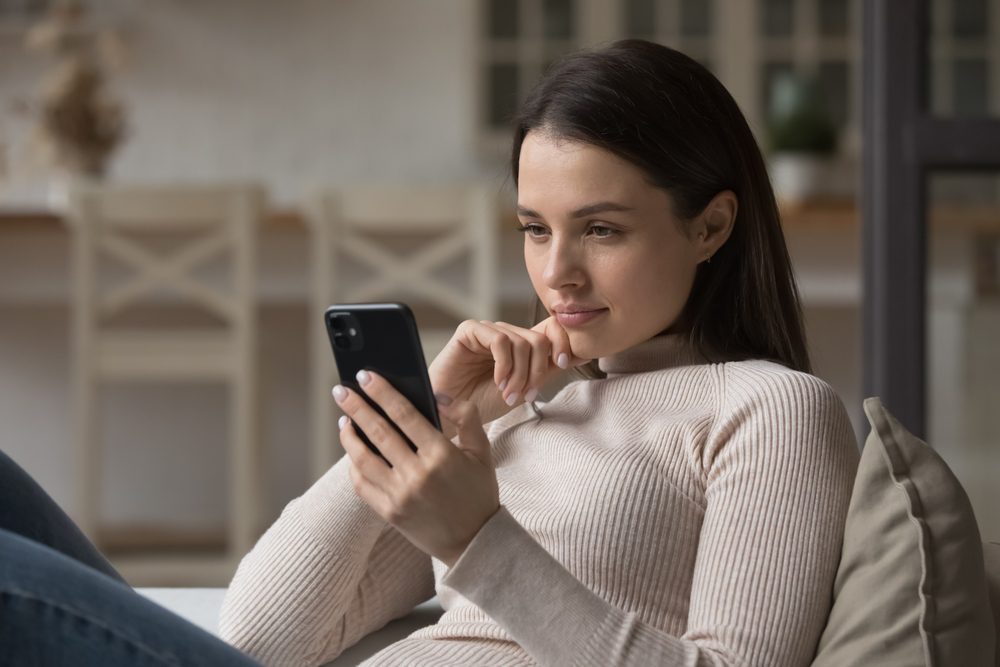 A person sitting on a couch looking at the clairvoyant readers