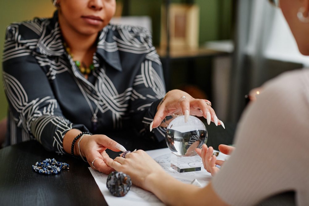 a person holding a person's hand doing Psychic Guidance.