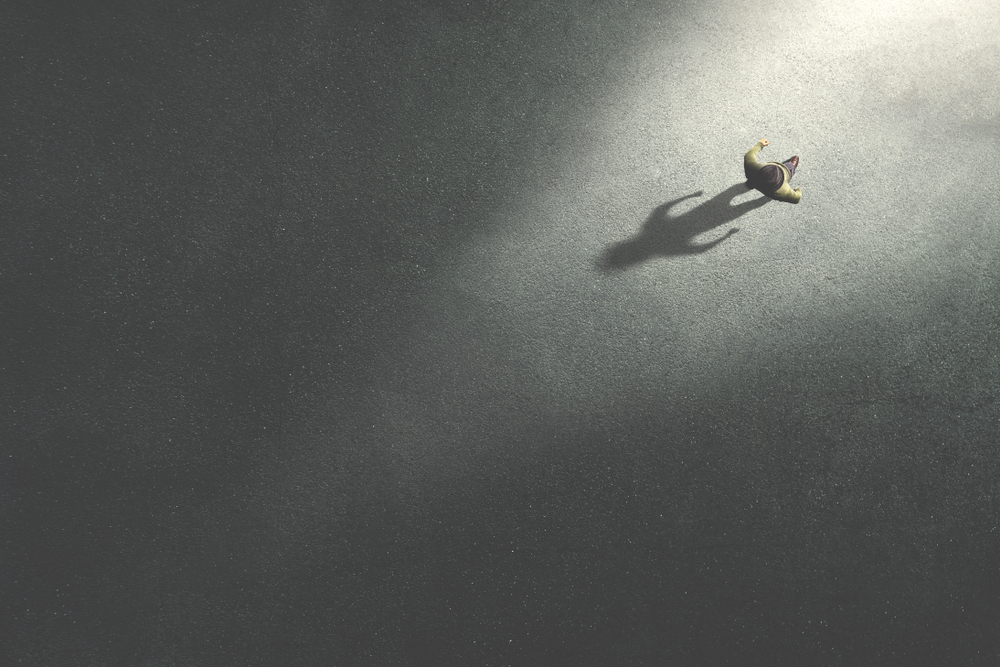 man walking in the night toward the light